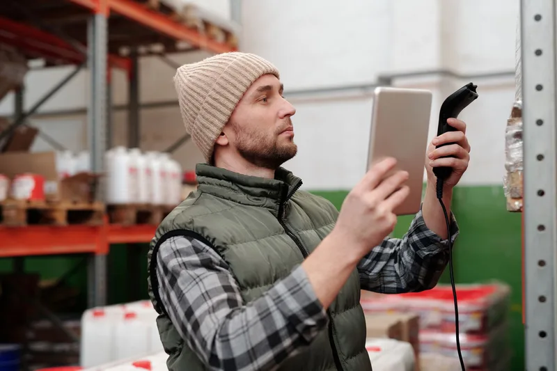 Warehouse worker checking inventory against a checklist