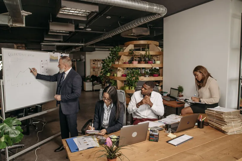 Team collaborating around a whiteboard during a planning meeting
