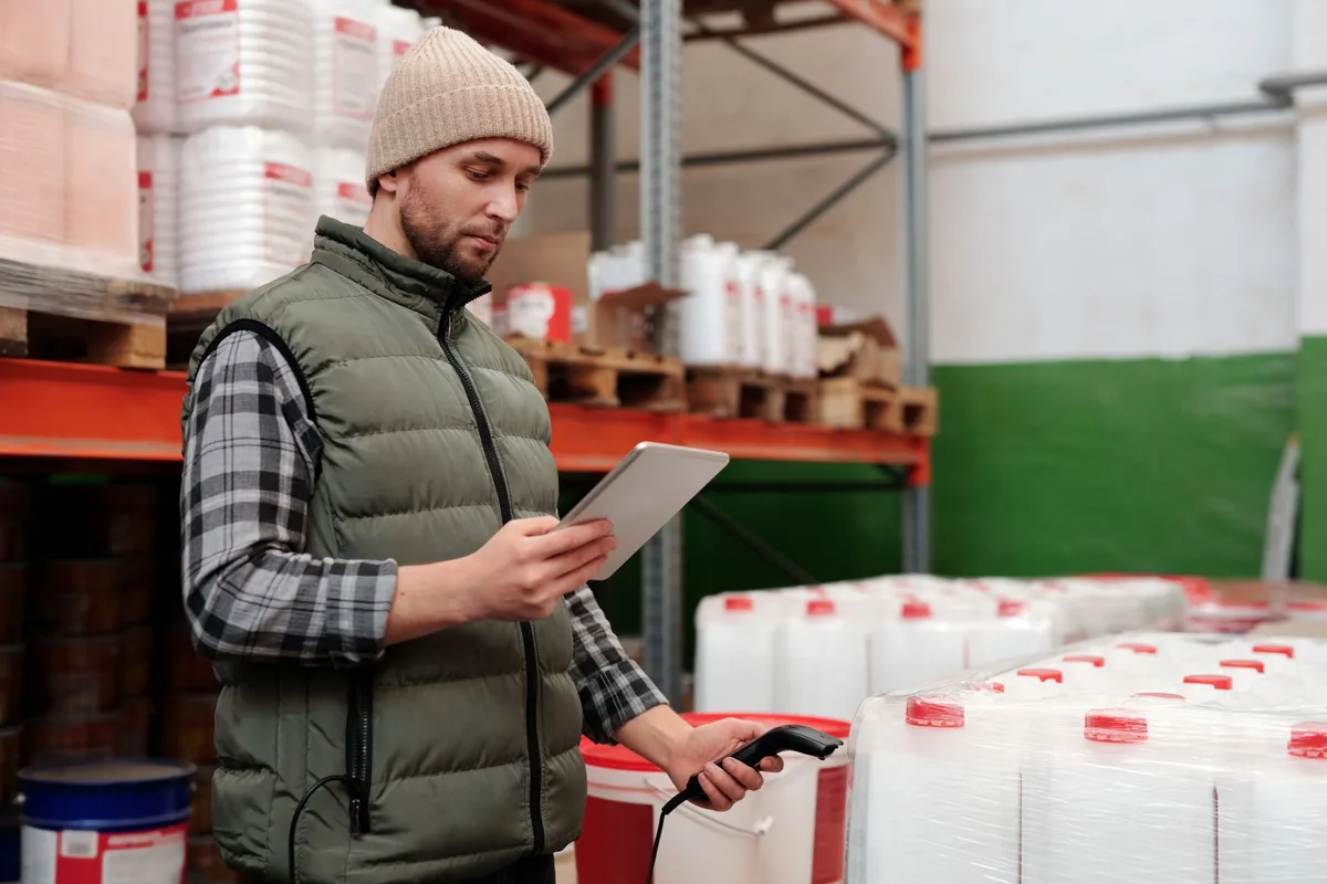 Warehouse worker scanning inventory boxes during ecommerce order fulfillment